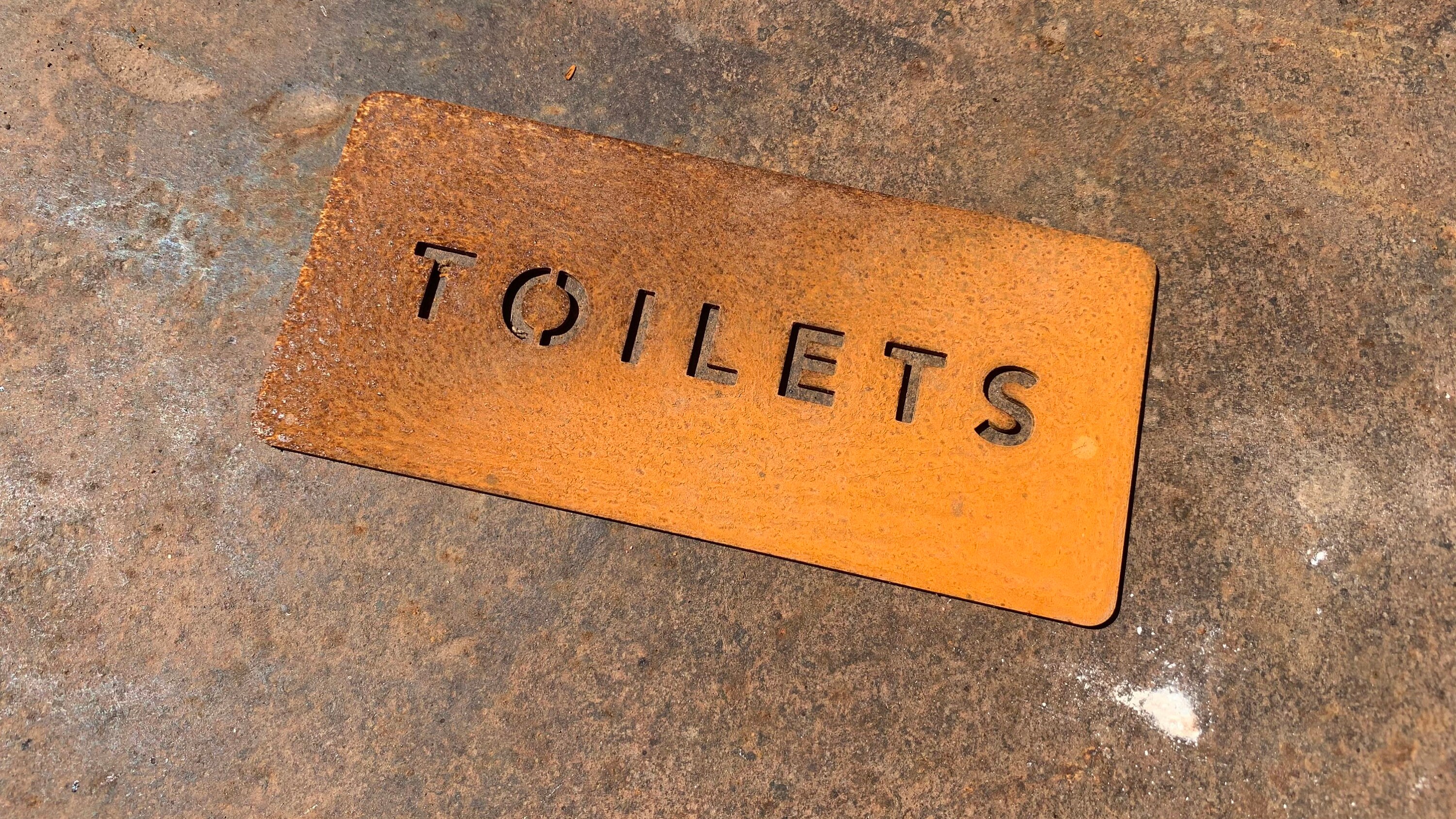 Cor-Ten Steel “Toilets” sign