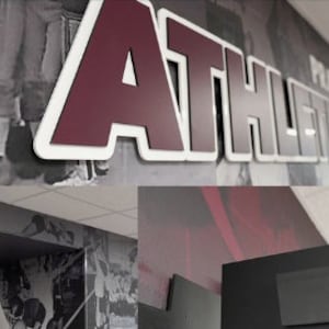 May include: A maroon and white "ATHLETICS" sign with a white outline and a black and white photo background.
