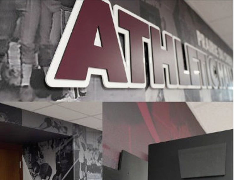 May include: A maroon and white "ATHLETICS" sign with a white outline and a black and white photo background.