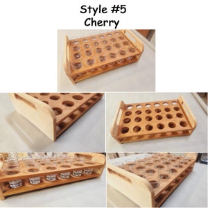 May include: A wooden shot glass holder with 24 slots, made of cherry wood. The holder has two handles and is ideal for serving shots of liquor.