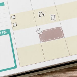 May include: A white planner with a light brown sticker with a book icon and a dashed border. The sticker is on a page with a checklist and other stickers including a pair of headphones and a phone.