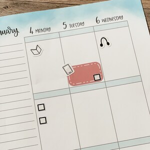 May include: A weekly planner with a light blue background and white grid lines. The days of the week are labeled at the top of each column. The days of the week are Monday, Tuesday, Wednesday. There are stickers on the planner, including a book, a phone, headphones, and a check box.