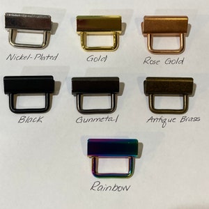 K&ouml;nnte beinhalten: Ein Satz mit 7 Metall-Schiebeschlie&szlig;en in verschiedenen Ausf&uuml;hrungen: vernickelt, gold, ros&eacute;gold, schwarz, gunmetal, antikes Messing und Regenbogen.