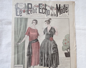 May include: A vintage magazine cover featuring two women in formal dresses. The magazine is titled "Le Petit Echo de la Mode" and the date is November 6, 1925. The women are wearing a red dress and a black dress. The text "Pour le Bal" is printed at the bottom of the image.
