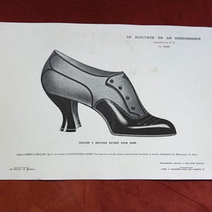 May include: A black and white vintage illustration of a button-up shoe titled SOULIER A BOUTONS ESTHER POUR DAME. The print features LE MONITEUR DE LA CORDONNERIE at the top and detailed text at the bottom, showcasing a high-heeled shoe design.
