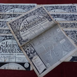 May include: A collection of vintage French magazines titled "Le Journal des Brodeuses," featuring intricate floral and decorative designs. The magazines are in black and white, with text and illustrations. The covers display the magazine title and issue numbers.