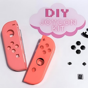May include: A DIY Joycon Kit with coral pink controller shells and black buttons. The kit includes various components like directional pads, buttons, and joystick caps, arranged on a white surface. The text "DIY JOYCON KIT" is displayed in pink.
