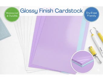 May include: A stack of glossy finish cardstock in shades of purple, white, and light blue. The cardstock is labeled as waterproof and durable, and dry-erase friendly. A close-up shows the layers of paper.