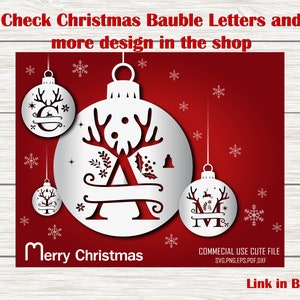 May include: A white Christmas bauble with a reindeer and the letter A inside. The bauble is on a red background with snowflakes. The text "Merry Christmas" is below the bauble. The text "COMMECIAL USE CUTE FILE SVG.PNG.EPS.PDF.DXF" is in the bottom right corner. The text "Link in Bio:" is in the bottom right corner.