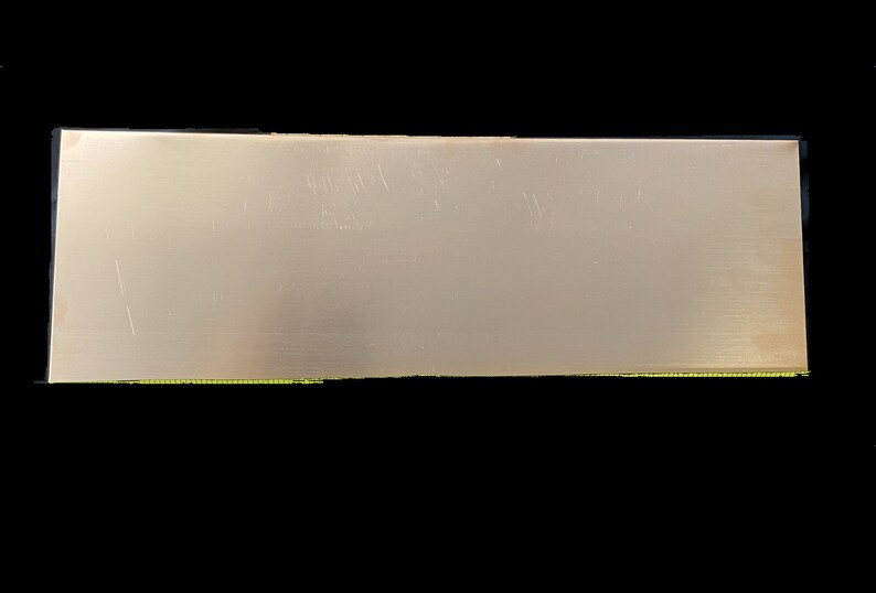 May include: A plain, rectangular, silver-colored metal sheet.