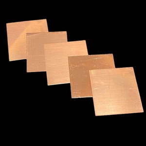 May include: Five square pieces of copper foil, arranged in a staggered pattern, with the largest piece at the bottom and the smallest piece at the top. The copper foil is a warm, reddish-brown color and has a slightly textured surface.