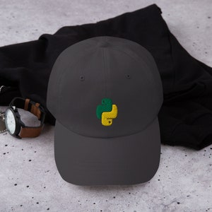 May include: A dark gray baseball cap with an embroidered green and yellow Python logo.