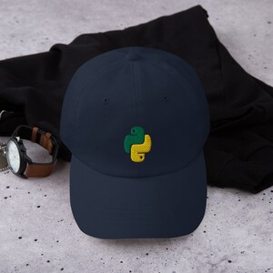 May include: A navy blue baseball cap with an embroidered green and yellow Python logo.