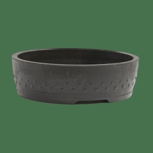 May include: A round, dark gray ceramic bonsai pot with a textured surface and a decorative pattern around the rim.