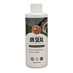 May include: A white plastic bottle of "JIN SEAL" by Ho Yoku Products. The label includes a logo, and text stating "100% Quality Guaranteed", "Superior Deadwood Whitening", and "Preserves Deadwood". The bottle contains 118 ml of product.
