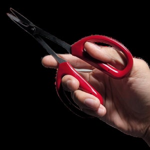 May include: Red handled pruning shears with black metal blades. The shears are open and held in a hand.