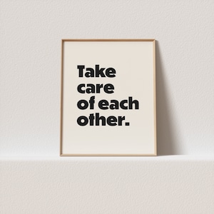 May include: A framed print with the text "Take care of each other." in black bold letters on a white background.