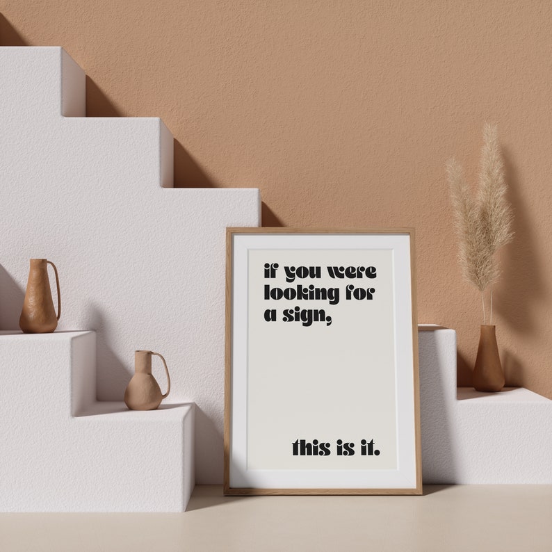 May include: A framed print with a white background and black text that reads "if you were looking for a sign, this is it."