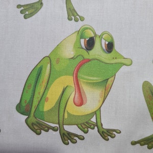 May include: A repeating pattern of cartoon frogs on a light background. The frogs are green with yellow bellies and red tongues. The frogs have large, sad eyes and are in various poses.