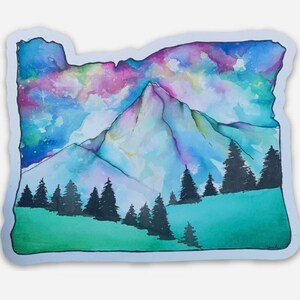 May include: A watercolor painting of a mountain range with a starry sky in the background. The mountain range is painted in shades of blue, purple, and pink, and the sky is painted in shades of blue and green. The painting is in the shape of the state of Oregon.