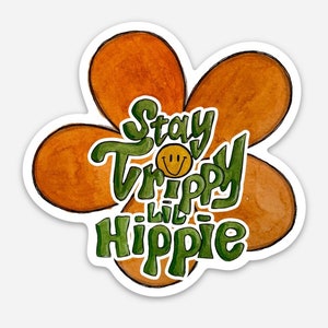 May include: A brown flower with a green outline and the text "Stay Trippy Lil Hippie" in green with a yellow smiley face.