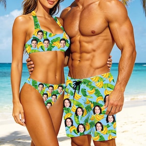 May include: A matching bikini and swim trunks set with a light blue background, featuring a pattern of bananas and faces. The bikini top is halter-style, and the bottoms are high-waisted. The swim trunks have a drawstring waist.