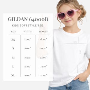 May include: White Gildan 64000B Kids Softstyle Tee with size chart. The chart shows measurements for XS, S, M, L, and XL sizes, with widths ranging from 14.00" to 19.00" and lengths from 18.00" to 25.00".