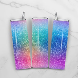 May include: Three stainless steel tumblers with lids and straws. The tumblers have a rainbow glitter design with a gradient of pink, orange, yellow, green, blue, and purple.