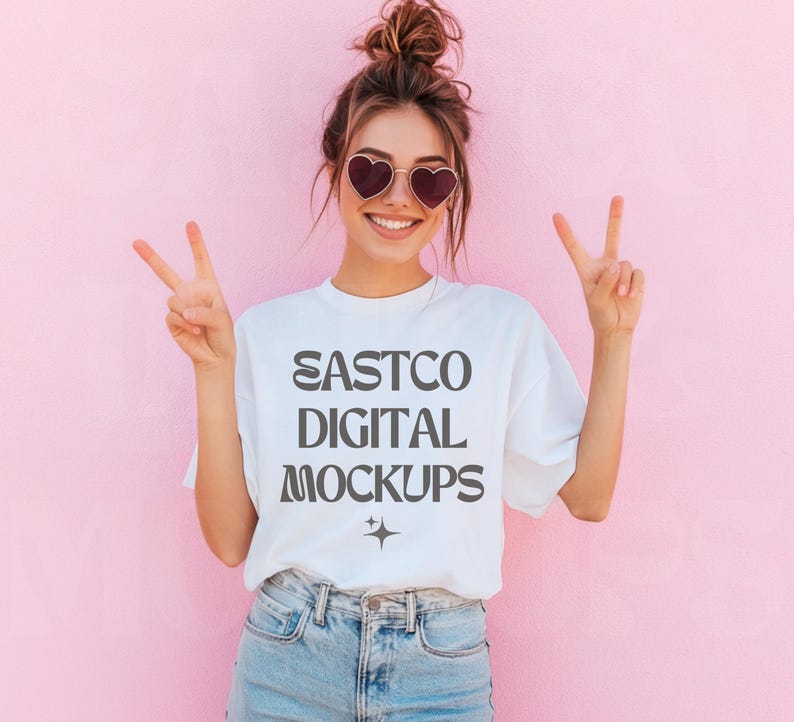May include: A white t-shirt with the text "EASTCO DIGITAL MOCKUPS" printed in gray on the front. The model is wearing the shirt and smiling at the camera.