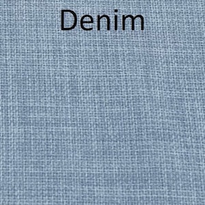 May include: A close-up of a blue denim fabric with a woven texture.