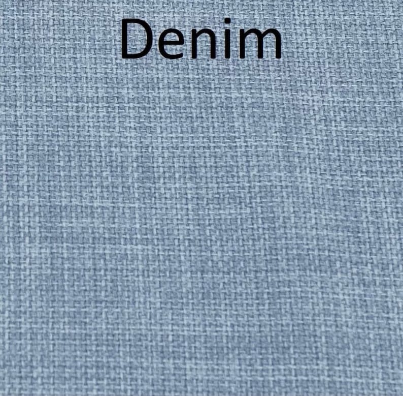 May include: A close-up of a blue denim fabric with a woven texture.