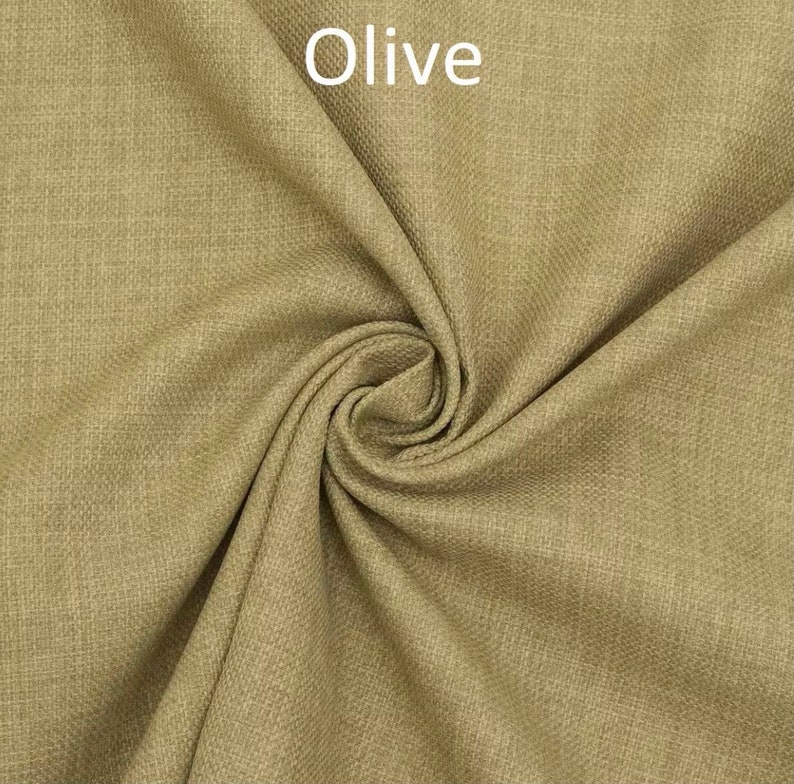 May include: Close-up of a textured fabric in a muted olive green color. The fabric is folded and twisted, showing its texture and drape.