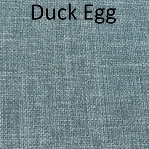 May include: A close-up of a blue textured fabric with the text "Duck Egg" printed in black.
