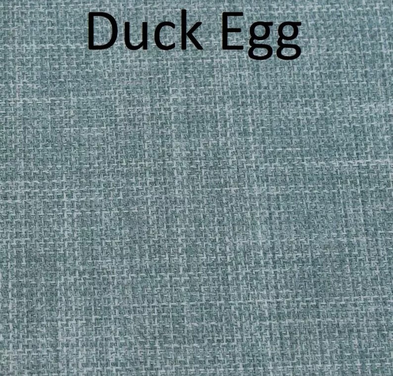May include: A close-up of a blue textured fabric with the text "Duck Egg" printed in black.