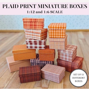 May include: A collection of 13 miniature boxes with plaid patterns in various colors, including red, orange, and brown. The boxes are in 1:12 and 1:6 scale. The text on the image reads "PLAID PRINT MINIATURE BOXES" and "SET OF 13 DIFFERENT BOXES."