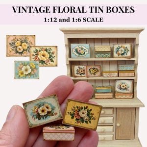 May include: Miniature vintage floral tin boxes in 1:12 and 1:6 scale. The boxes feature floral designs in various colors, including yellow, pink, and blue. Some boxes are held in a hand, while others are displayed on a miniature cabinet.