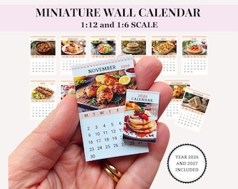 May include: Miniature wall calendars in 1:12 and 1:6 scale. The calendars feature monthly images of food, with a focus on the year 2026 and 2027. The November 2026 calendar is held in a hand, with a close-up of a food image.