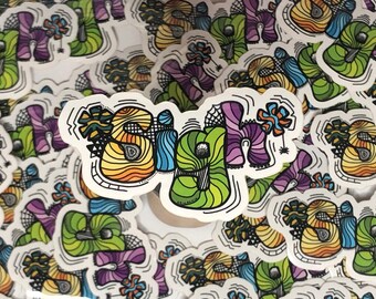 May include: A collection of colorful stickers with the word "Sigh" written in a whimsical, stylized font. The stickers are made of white vinyl with black outlines and feature a variety of colors, including yellow, orange, green, blue, and purple.