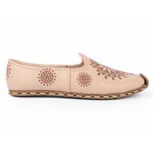 Chic white leather trainers for versatile everyday wear, blending casual style with sophistication.