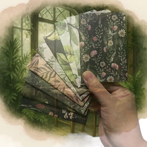 May include: A set of small rectangular paper cards featuring various botanical patterns including dark green foliage, pink flowers, and leafy designs. The cards are fanned out, displaying different prints, with the word Fernvale printed below.
