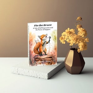 May include: A book titled "Fio the Brave: A Tale of Self-Expression and the Power of Support" by Happy Art Limited. The cover features a watercolor illustration of a fox holding a microphone, standing on a rock in a forest setting.