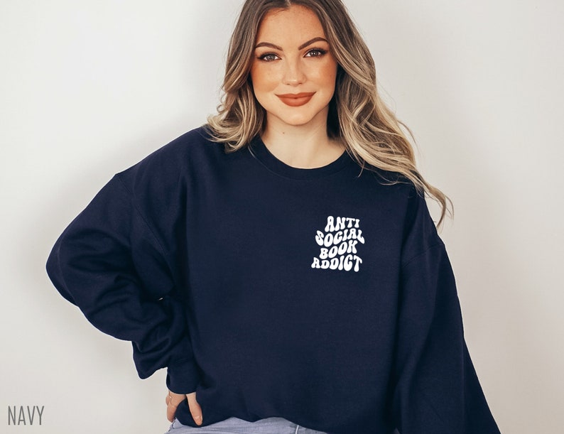 May include: Navy blue sweatshirt with the text "Anti Social Book Addict" in white, a perfect gift for book lovers. The sweatshirt is a comfortable, casual style.