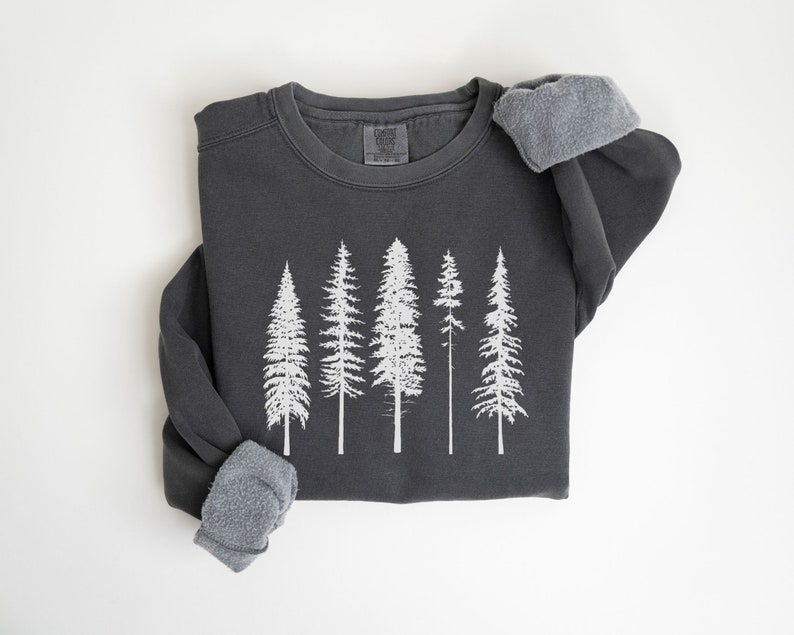 May include: A dark gray sweatshirt with a white print of five stylized pine trees.