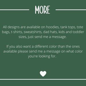 May include: A dark green background with white text that reads "MORE". Below, the text states that designs are available on various items, including hoodies, t-shirts, and tote bags. A white heart graphic is at the bottom.