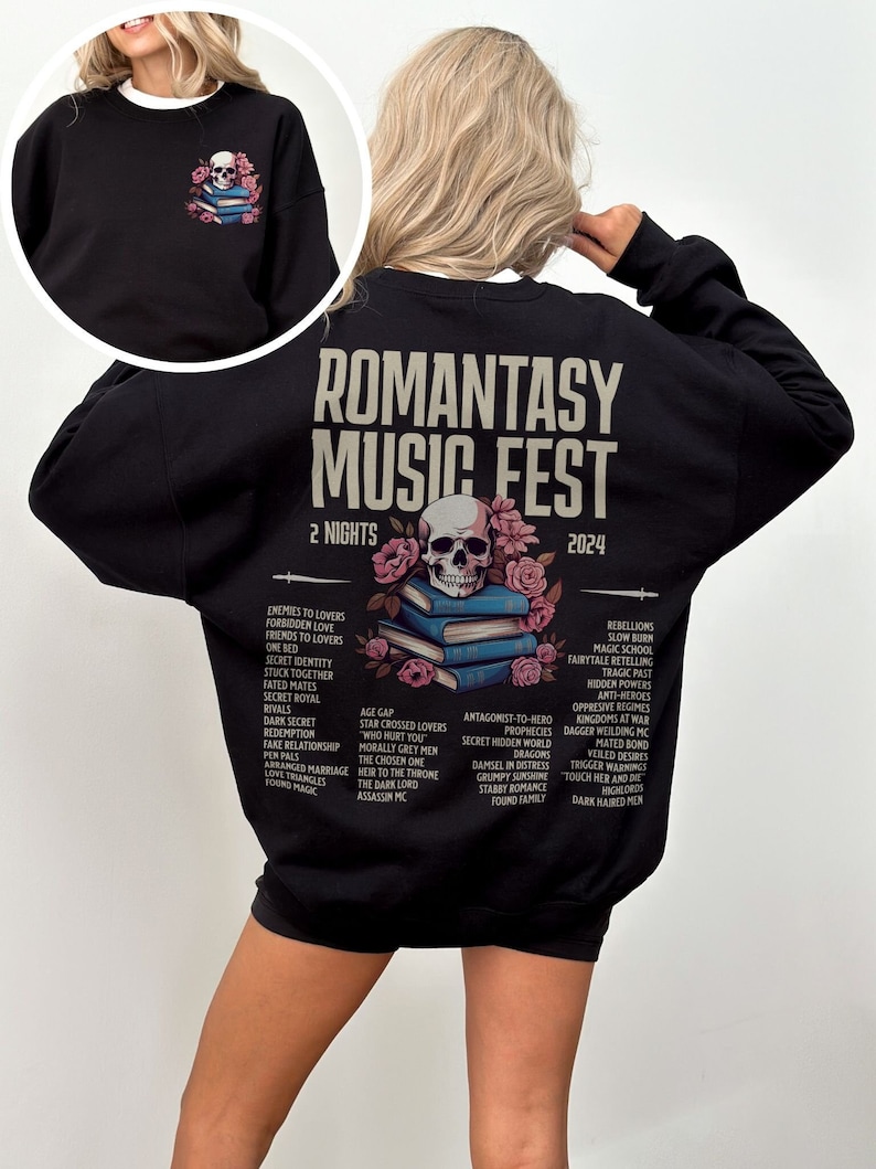 May include: Black sweatshirt with "ROMANTASY MUSIC FEST 2024" text and a skull graphic. The back features a list of romance novel tropes. A smaller graphic of a skull, books, and flowers is on the front.