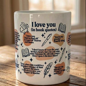 Könnte beinhalten: Weiße Keramik-Tasse mit dem Text "I love you (in book quotes)". Die Tasse zeigt Zitate aus verschiedenen Büchern sowie Illustrationen eines Drachen, Bücher, Stifte, Federn und Sterne. Die Tasse ist mit orangefarbenen und marineblauen Akzenten verziert.
