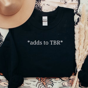 May include: Black sweatshirt with white text that reads "*adds to TBR*"