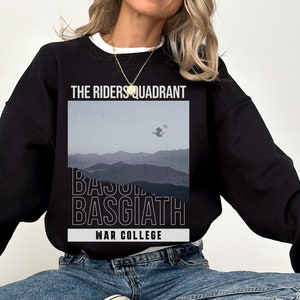 Puede incluir: Sudadera negra con un estampado gr&aacute;fico de una cordillera y el texto "The Riders Quadrant Basquiath War College".