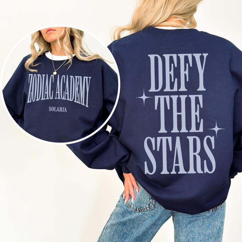 May include: Navy blue sweatshirt with the text "Defy the Stars" printed on the back and "Zodiac Academy Solaria" printed on the front.
