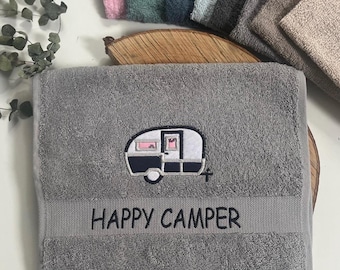 Puede incluir: Toalla de mano gris con una caravana bordada y el texto "HAPPY CAMPER".